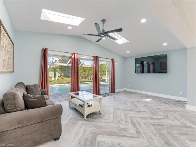 Den with acess to pool, vaulted ceiling