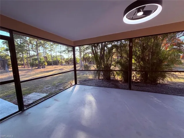 Unfurnished sunroom featuring finished concrete floors