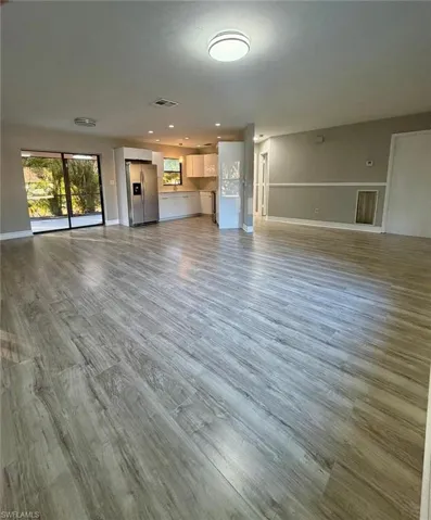 Unfurnished living room with light wood-type flooring and recessed lighting