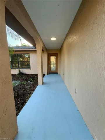 View of exterior entry featuring a patio area and stucco siding