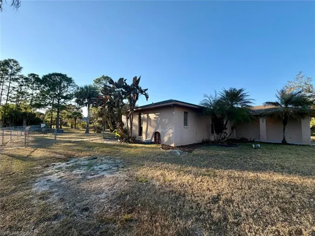 View of side of property featuring stucco siding