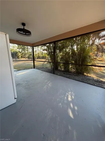 View of patio with a sunroom