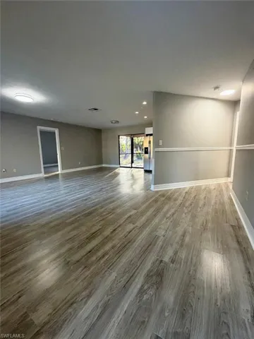Spare room featuring light wood-style floors and baseboards