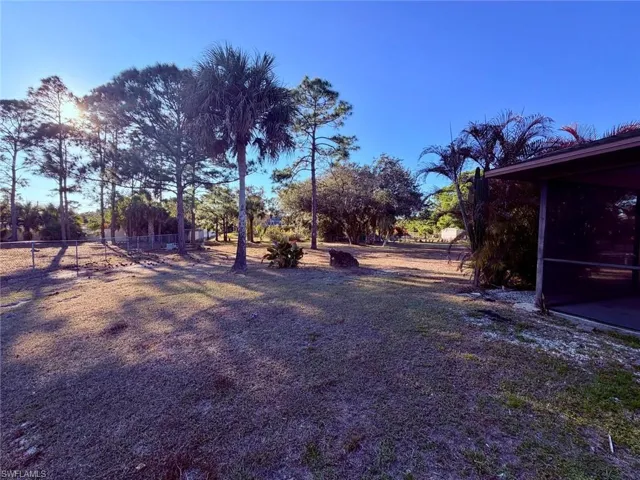View of yard with a sunroom