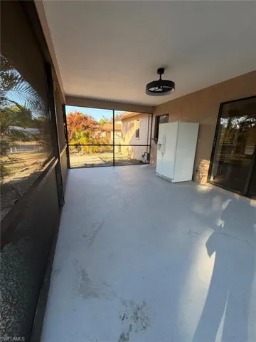 View of patio featuring a sunroom