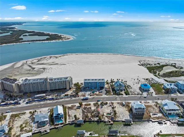 Aerial view featuring a beach view and a water view