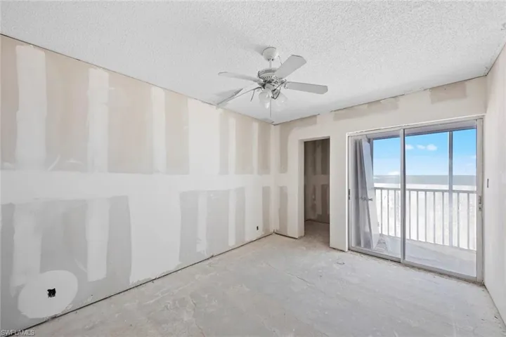 Unfurnished room featuring a textured ceiling and ceiling fan
