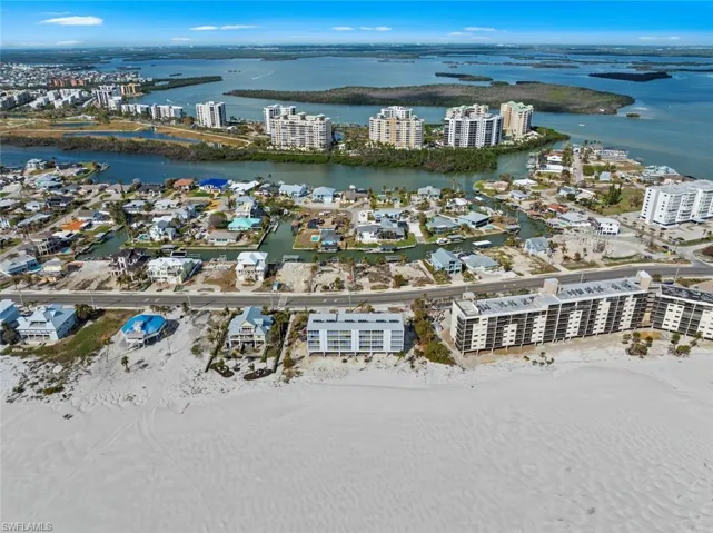 Drone / aerial view with a city view and a water view