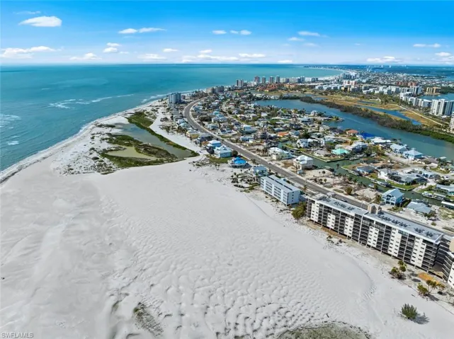 Aerial view featuring a view of city, a beach view, and a water view
