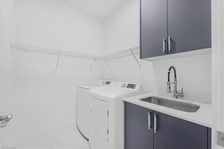 Laundry room with cabinet space and washer and clothes dryer