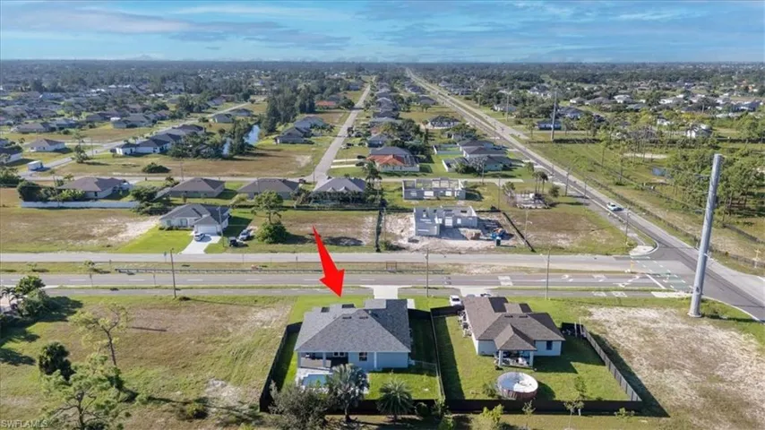 Aerial view of property's location featuring nearby suburban area