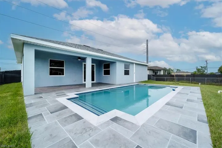 Back of house featuring a fenced backyard, a ceiling fan, a patio, and stucco siding