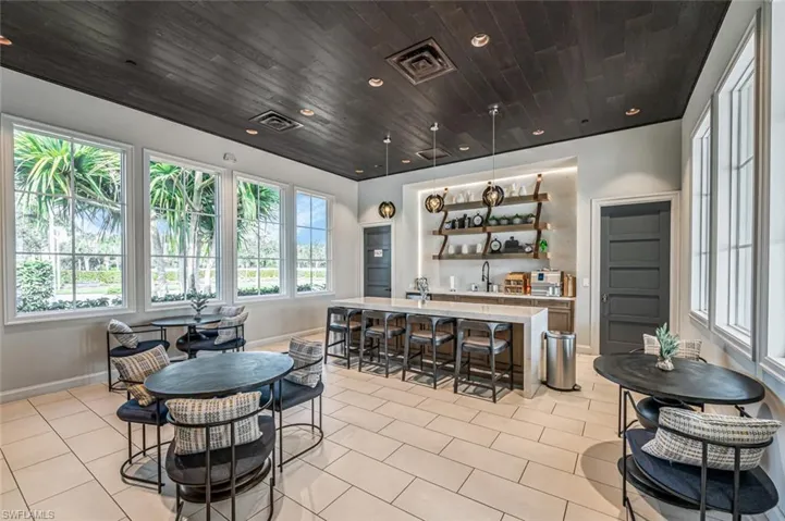 Tiled dining area with sink and wood ceiling