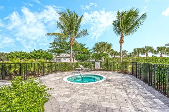 View of pool with a patio and a community hot tub