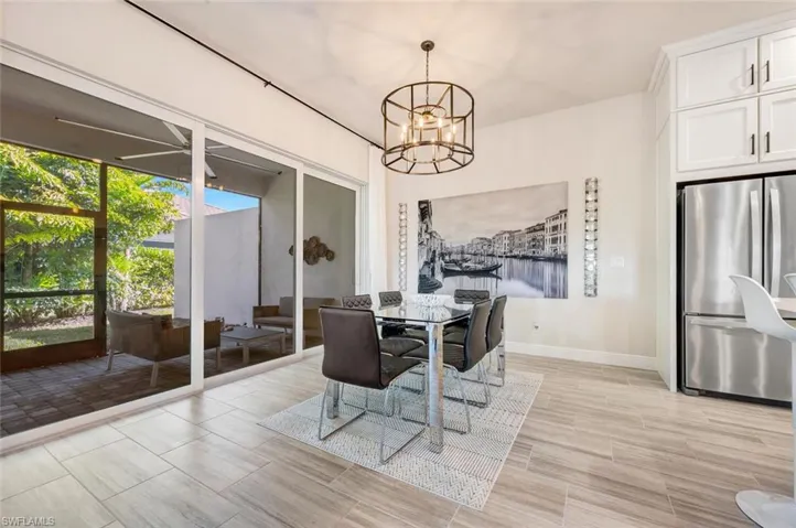 Tiled dining space featuring a chandelier