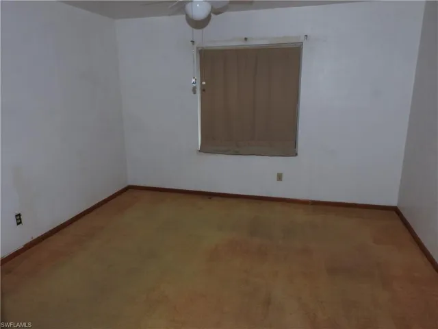 Spare room with ceiling fan and light carpet