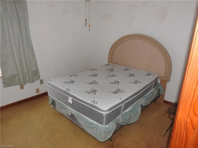 Bedroom with light colored carpet