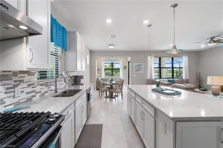 Kitchen featuring a modern tile backsplash and pendant lighting