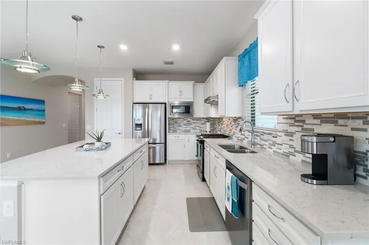 Kitchen features an abundance of quartz counter space