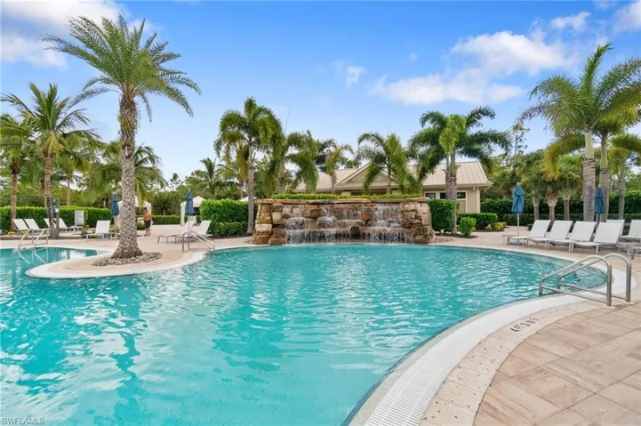 Resort Style heated swimming pool with waterfall rock wall