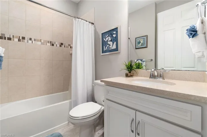 Guest bathroom w/quartz counter top and linen closet behind door