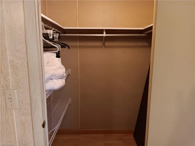 Walk in closet featuring light wood-style flooring