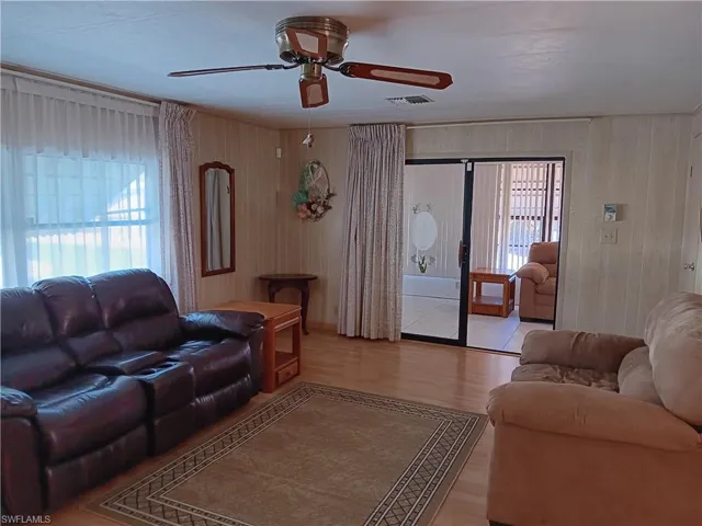 Living room featuring wood finished floors and a ceiling fan