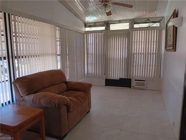 Living area with lofted ceiling and a ceiling fan