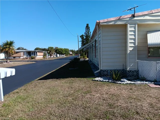 View of asphalt road featuring a residential view