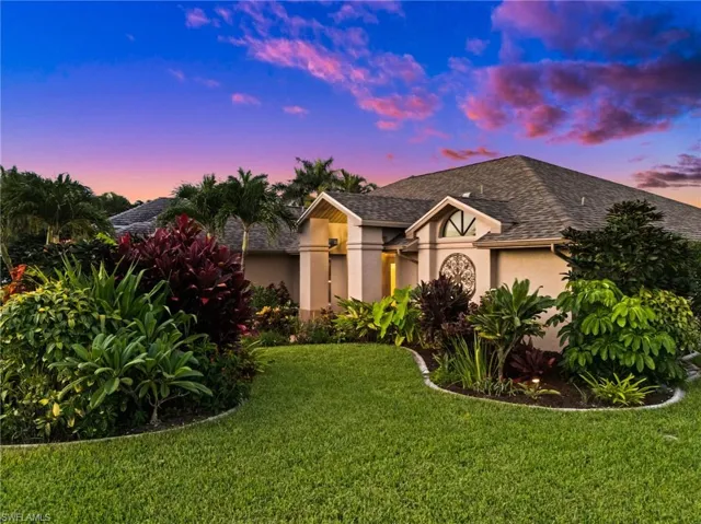 Lush tropical landscaping surrounds the home.