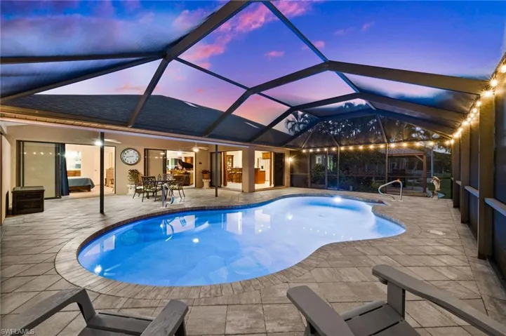 Patio pavers and screen surround the pool