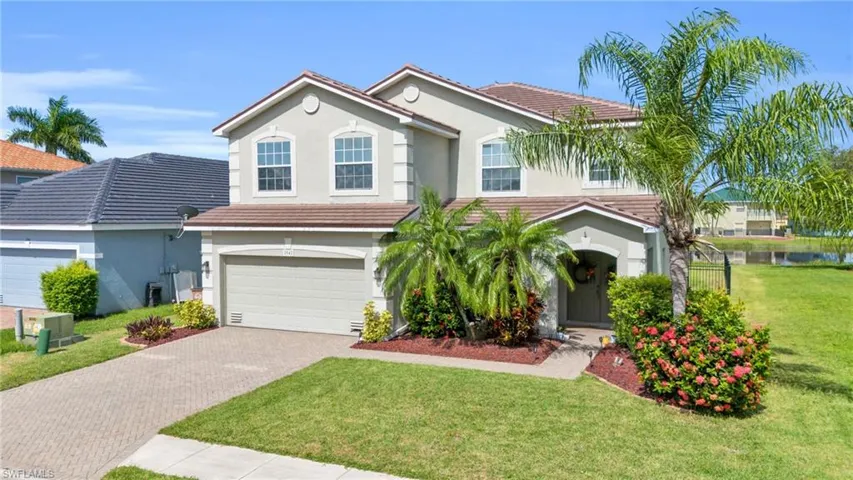 View of front of house with a garage and a front yard