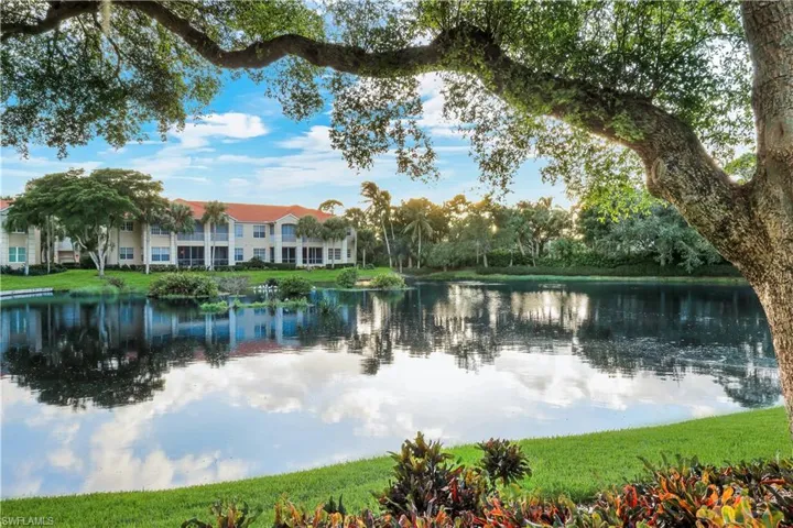 The tranquil lake reflects the warm colors of a beautiful Bonita Bay sunset.