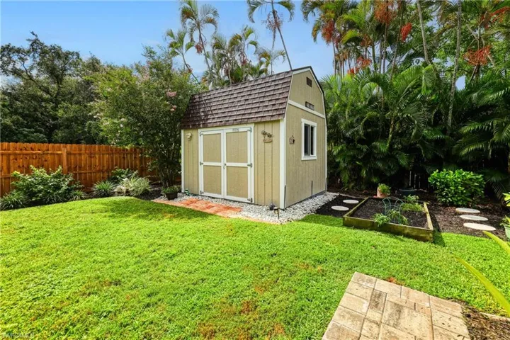 View of outbuilding with a lawn