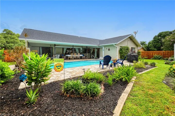 View of swimming pool featuring a grill, a yard, and a patio