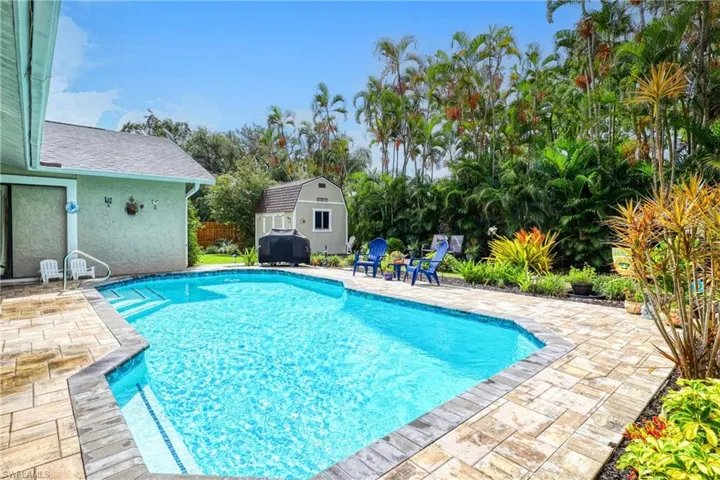 View of swimming pool with a storage unit and a patio