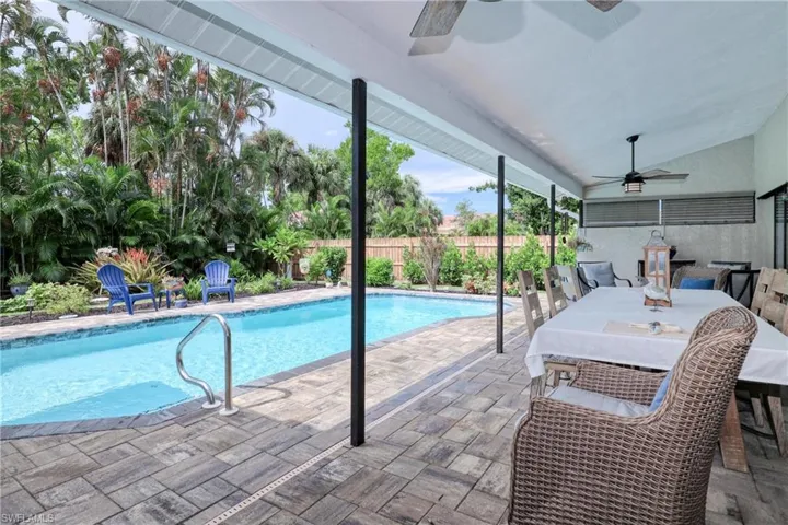 View of swimming pool featuring ceiling fan and a patio area