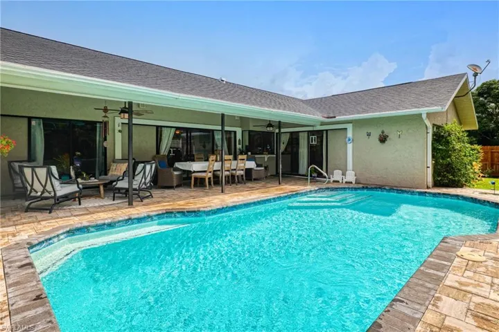 View of pool featuring a patio area and ceiling fan