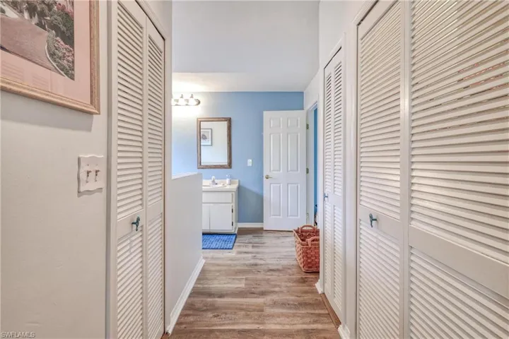 Corridor featuring sink and hardwood / wood-style floors
