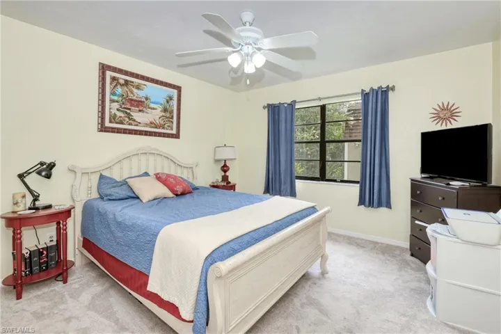 Carpeted bedroom with ceiling fan