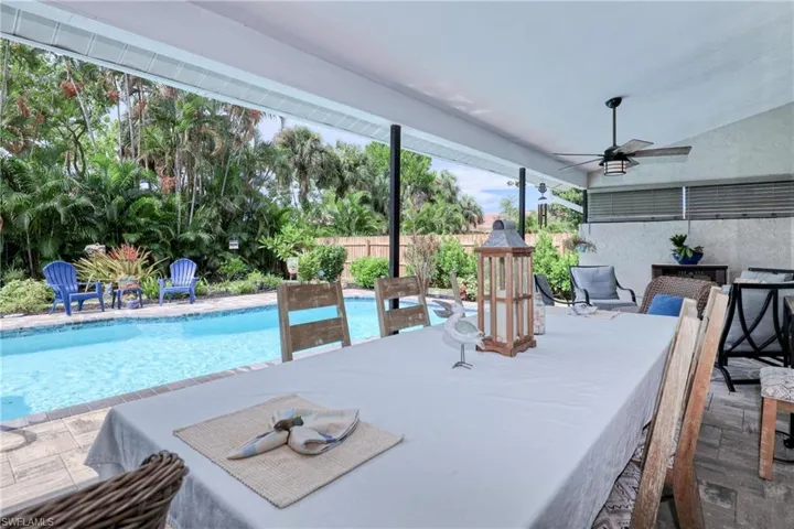 View of swimming pool with ceiling fan and a patio