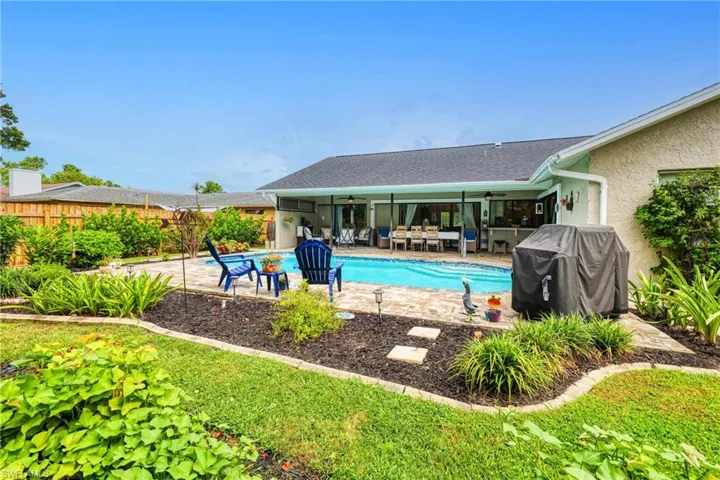 View of swimming pool with a grill and a patio