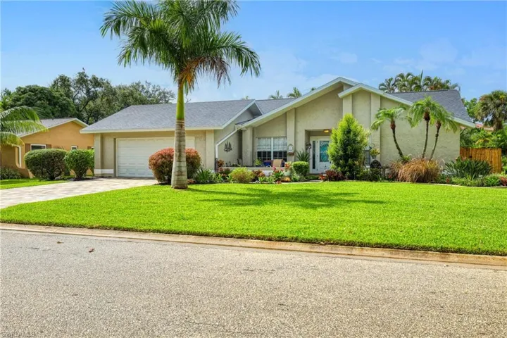 Ranch-style home featuring a garage and a front yard