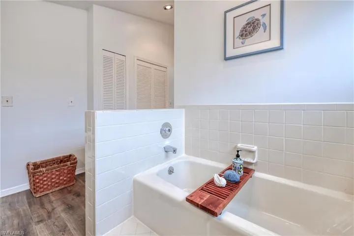 Bathroom featuring a tub and wood-type flooring