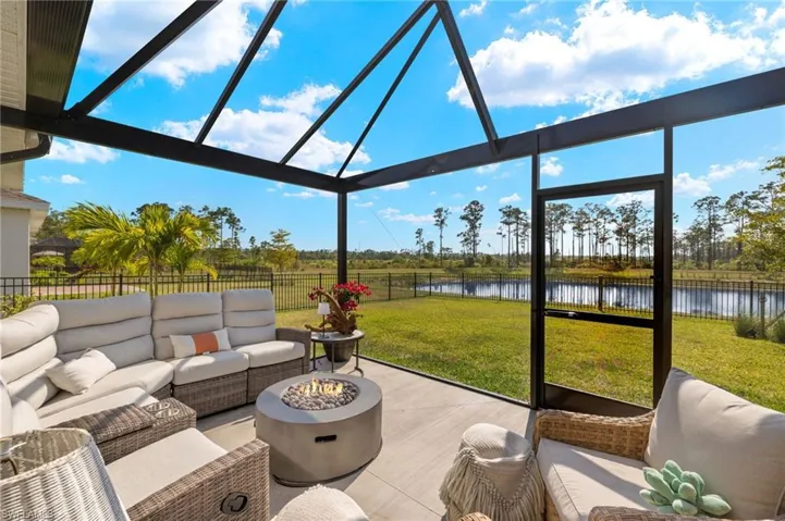 Patio with screen enclosure, water and preserve view, fenced backyard, and an outdoor living space.