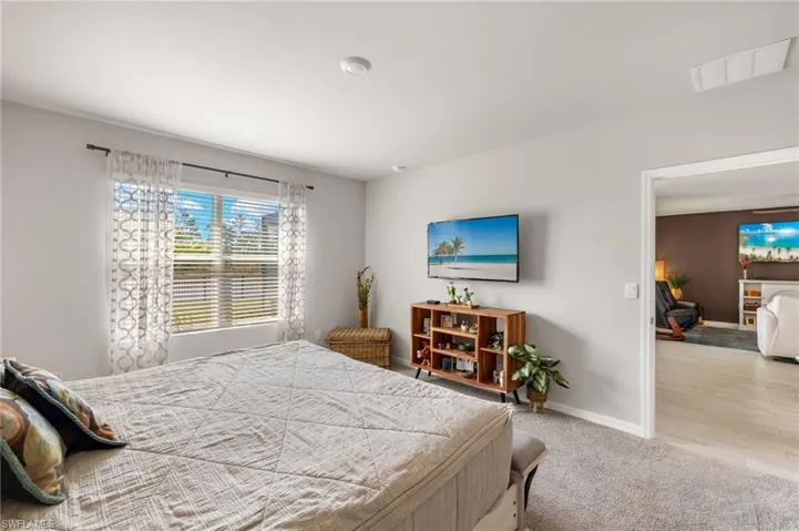 Primary bedroom has beautiful views of the lake and preserve