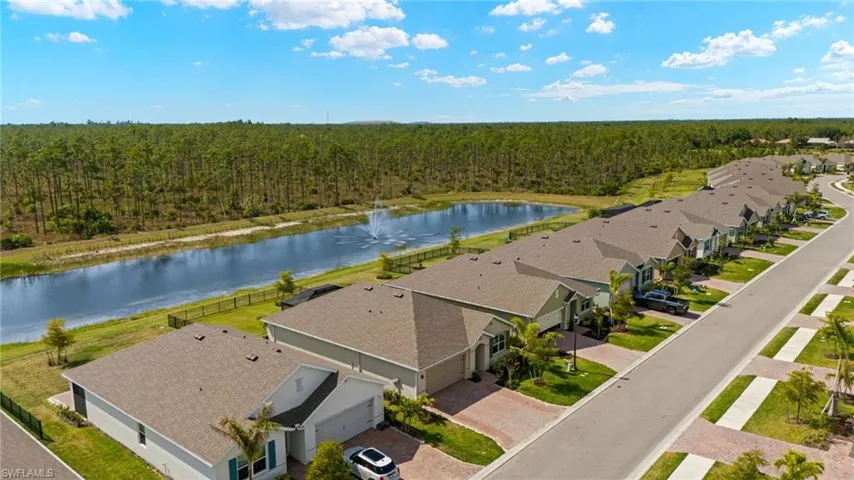 Drone / aerial view featuring a wooded view, a water view, and a residential view