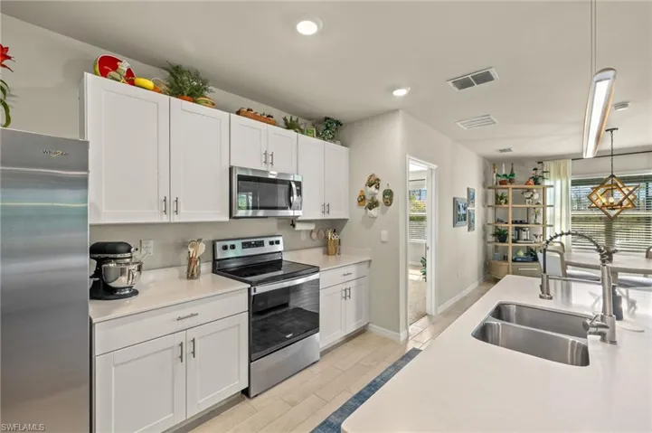 Kitchen featuring white cabinetry, visible vents, a sink, and stainless steel appliances