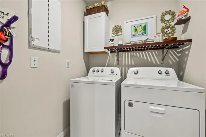 Laundry room with washing machine and dryer and cabinet space