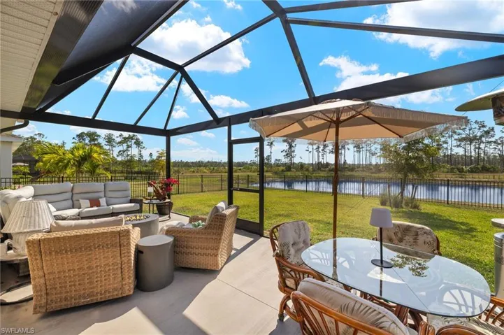 View of patio with an outdoor hangout area, a water view, a fenced backyard, and a lanai